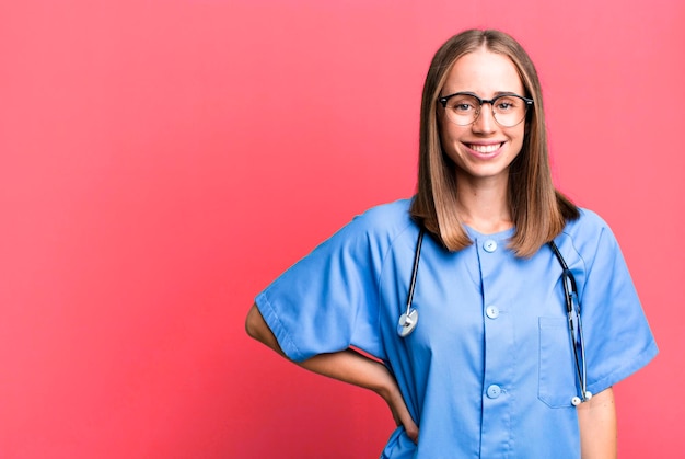 Photo smiling happily with a hand on hip and confident