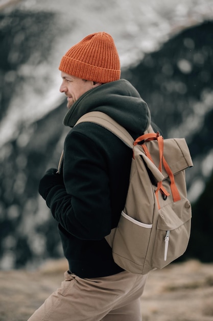 Smiling hiker enjoying a snowy mountainous adventure