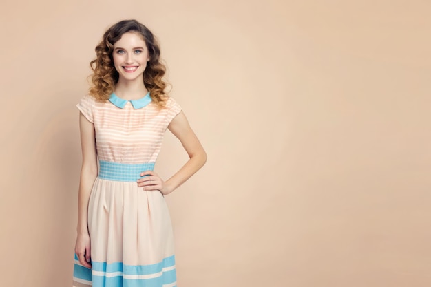 Photo smiling hipster in a blue and pink dress poses in a studio setting generative ai