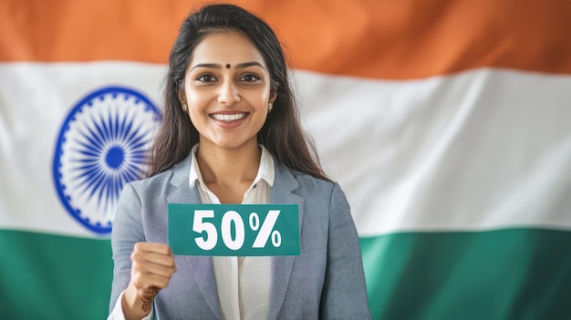 Smiling indian businesswoman holding 50 sign and pointing it against indian flag background