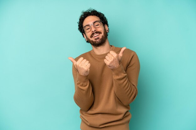 Smiling joyfully and looking happy feeling carefree and positive with both thumbs up