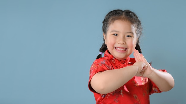 Smiling little asian child girls in red chinese traditional dress.Happy Chinese new year concept.