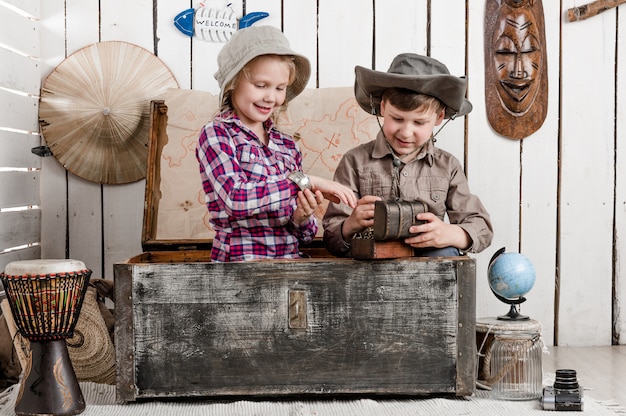 Smiling little boy and girl discovers treasure