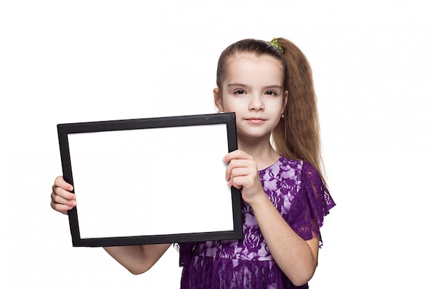 Smiling little girl holding blank, Isolated on white