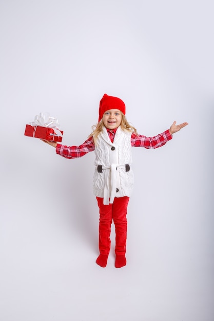 smiling little girl in Santa hat with gift box isolated on white background