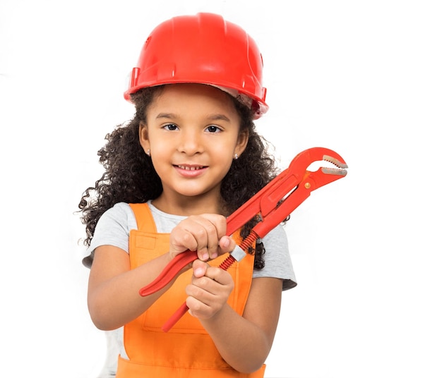 Smiling little girlworker with pliers in hands isolated