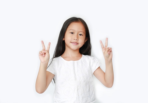 Smiling little kid girl showing two finger gesture as sign as fighting isolated