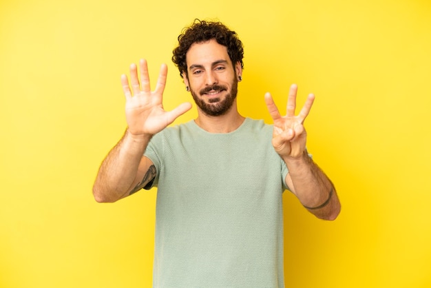 Smiling and looking friendly showing number eight or eighth with hand forward counting down