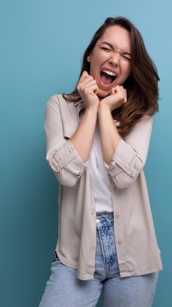 Smiling lovely brunette year old female person in shirt and jeans is happy