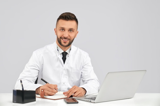 Smiling male doctor working in office