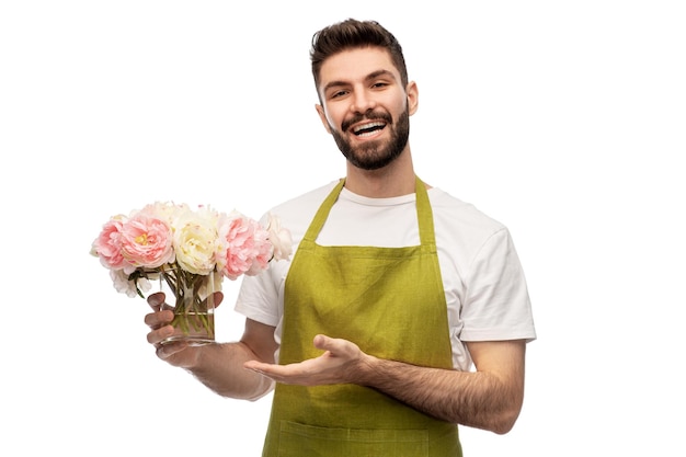 smiling male gardener with bunch of peony flowers