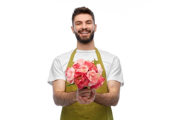 smiling male gardener with bunch of peony flowers