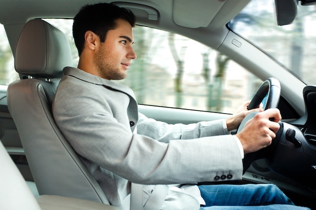 Smiling man driving his car