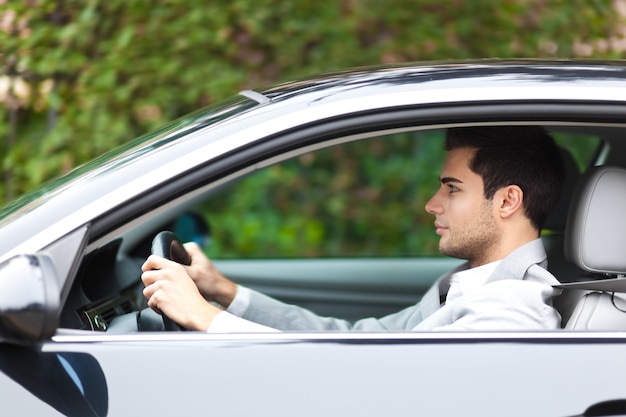 Smiling man driving his car