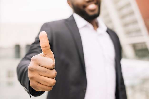 Smiling man gesturing thumb up