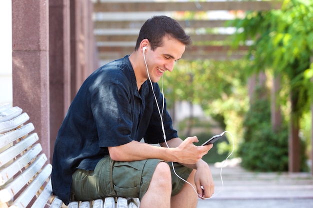 Smiling man listening to music on cell phone