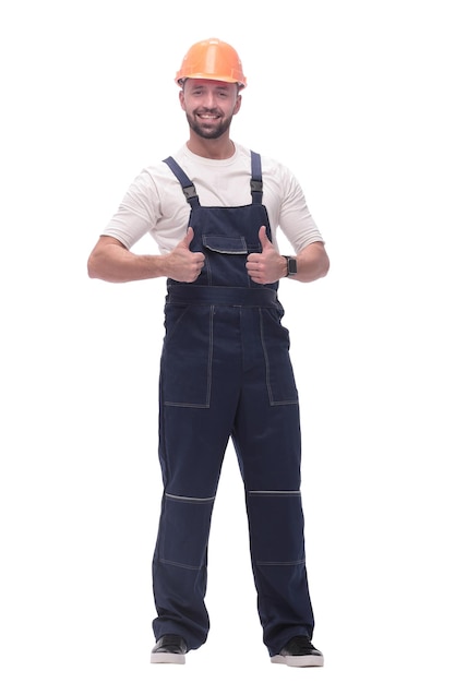 Smiling man in overalls showing thumbs up isolated on white