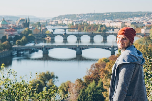 Smiling man portrait with autumn prague on background