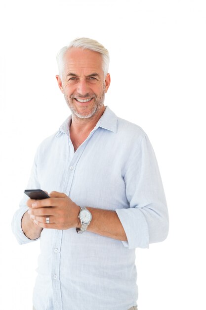 Smiling man sending a text message on white background