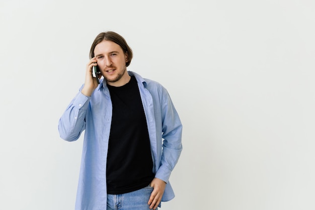 Smiling man talking on a mobile phone isolated on white background