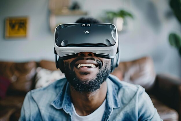 Smiling man using VR headset enjoying virtual reality experience in a modern home setting highlig