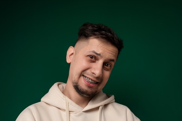 Smiling man in white hoodie