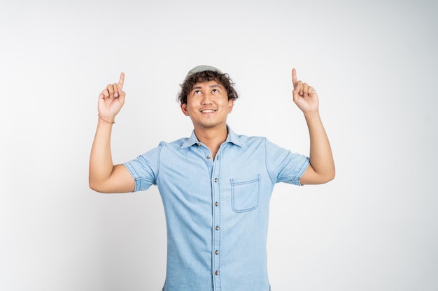 Smiling man with finger pointing up on isolated background