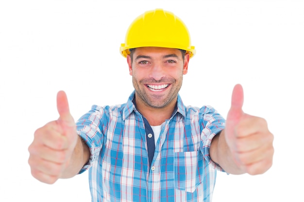 Smiling manual worker gesturing thumbs up