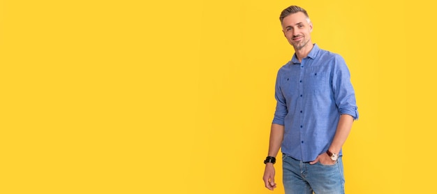 Smiling mature man with wrist watch on yellow background fashion Man face portrait banner with copy space