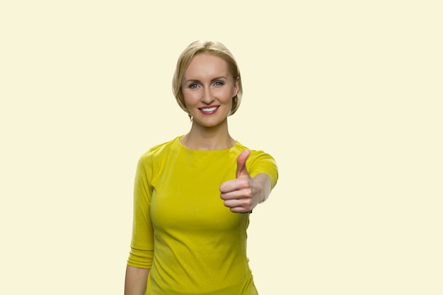 Smiling mature woman is showing thumb up