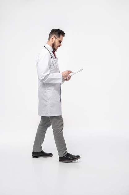 Smiling medical doctor. Isolated over white wall