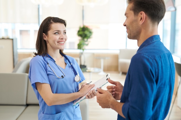 Smiling Nurse Talking to Patient