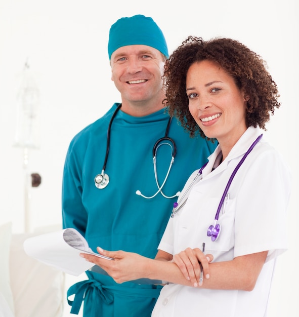 Smiling nurse with surgeon in blue scrubs 