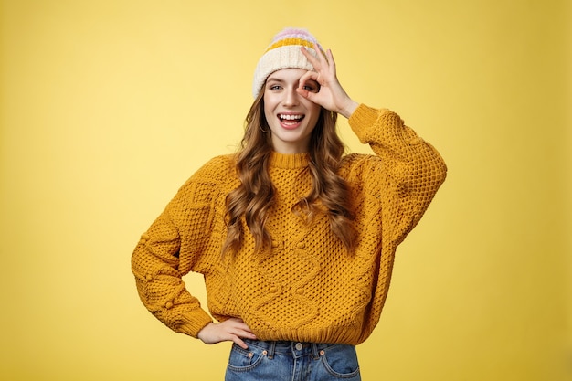 Smiling optimistic happy charming girl show okay ok gesture assuring everthing alright keep up supporting you, like awesome idea excited try out, standing satisfied yellow background