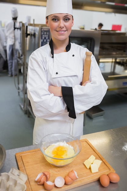 Smiling pastry chef with rolling pin