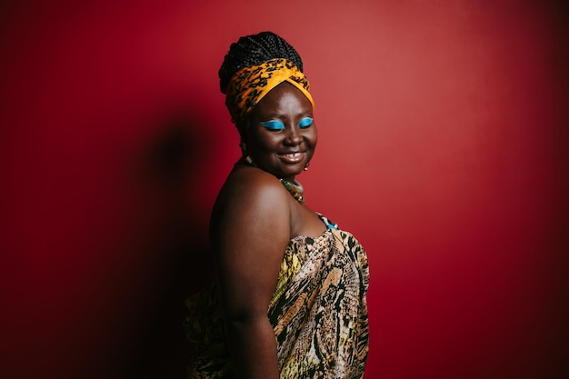 Smiling plus size African woman with beautiful makeup wearing traditional headwear