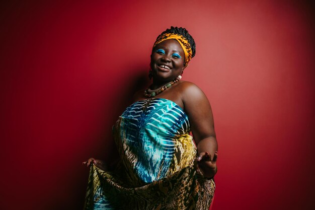 Smiling plus size african woman with beautiful makeup wearing traditional headwear