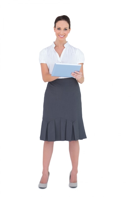 Smiling pretty businesswoman using tablet computer