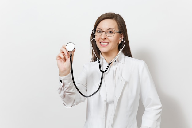 Smiling pretty confident experienced beautiful young doctor woman using stethoscope isolated on white background. Female doctor in medical gown glasses. Healthcare personnel, health, medicine concept.