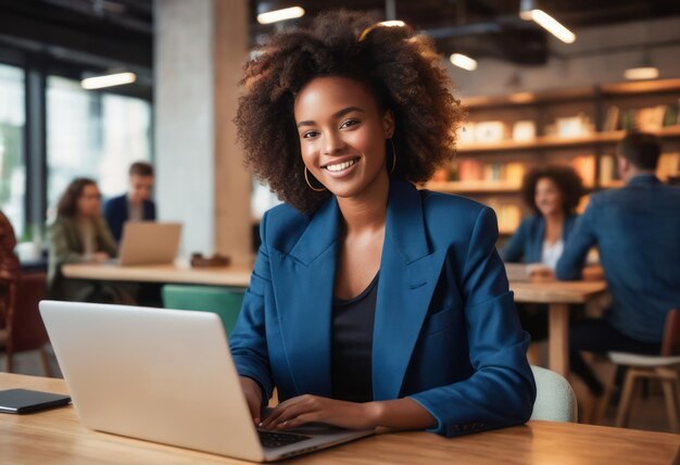 Smiling professional woman working on laptop contemporary office setting with team in background