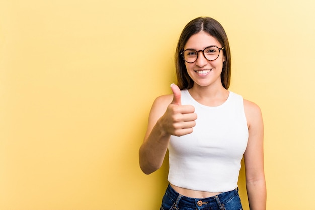 Smiling and raising thumb up