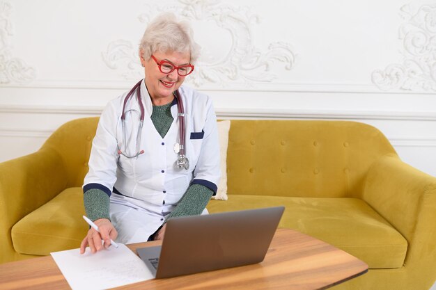 Smiling s middle aged female doctor looking at camera happy mature elegant old lady posing at hospital