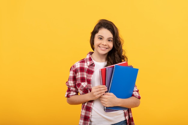 Smiling school child ready to study with copybooks, knowledge.