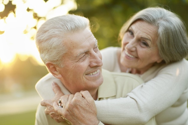 Smiling senior couple in autumn park