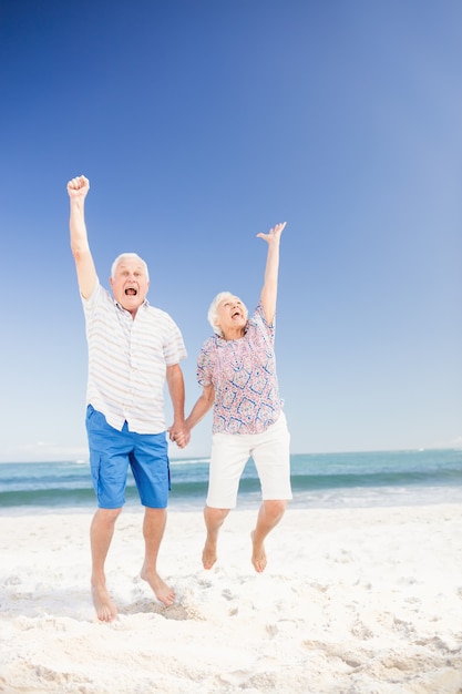 Smiling senior couple jumping