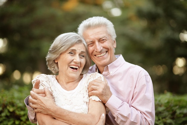 Smiling senior couple smiling in park