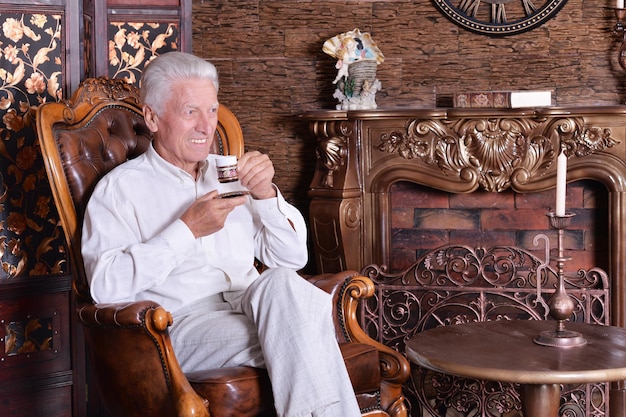 Smiling senior man drinking coffee