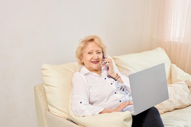 Smiling senior woman having conversation on phone