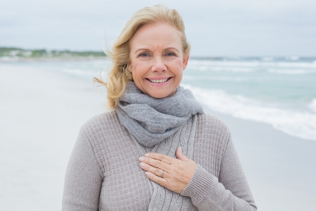 Smiling senior woman relaxing at beach