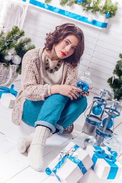 Smiling sexy beautiful girl in jeans and sweater